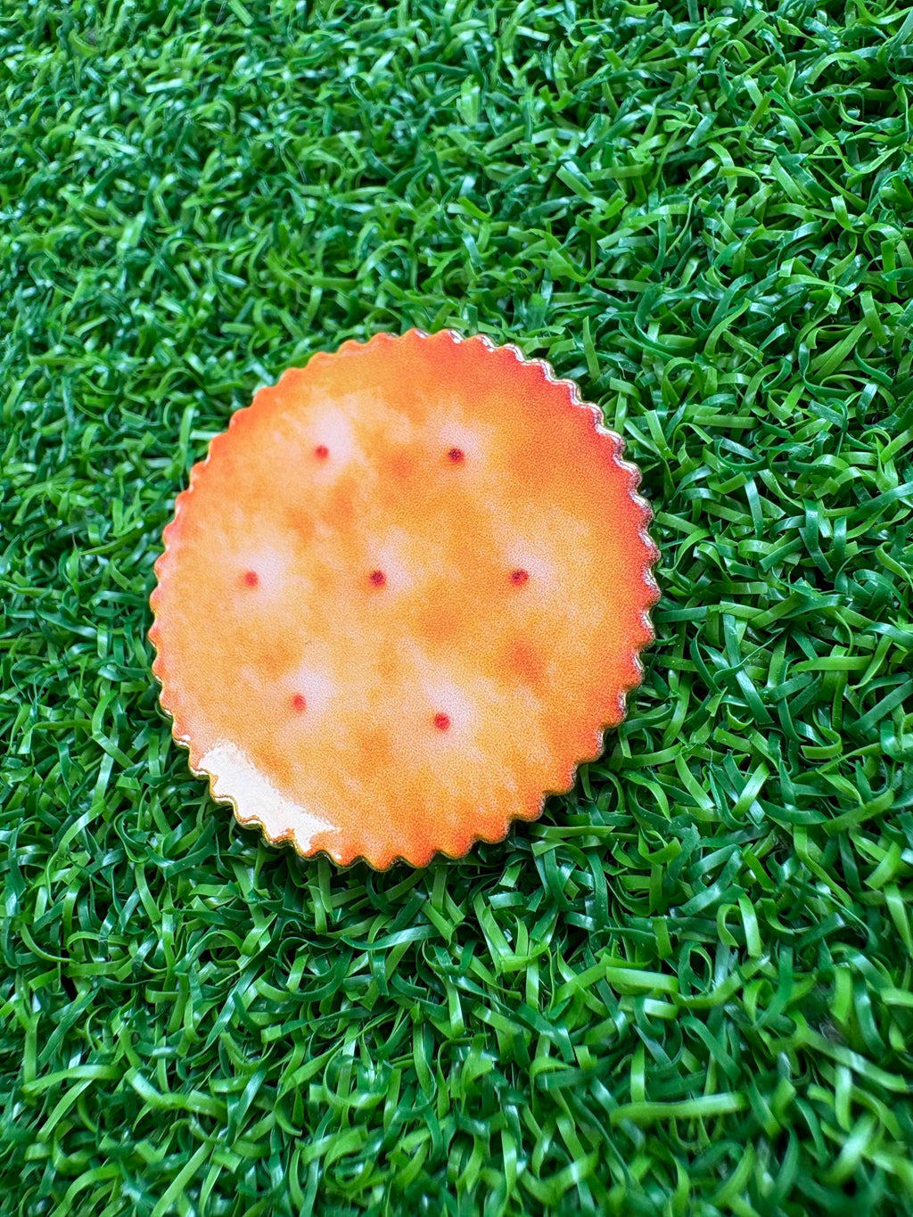 Unique cracker/biscuit golf ball marker with magnetic hat clip
