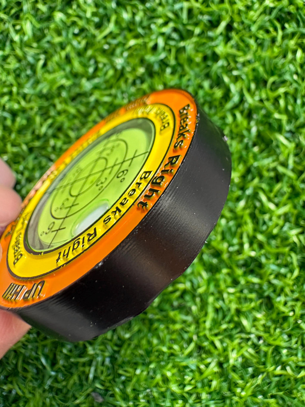 Dual-sided pizza style unique golf green reading, slope level, with ball marker attached